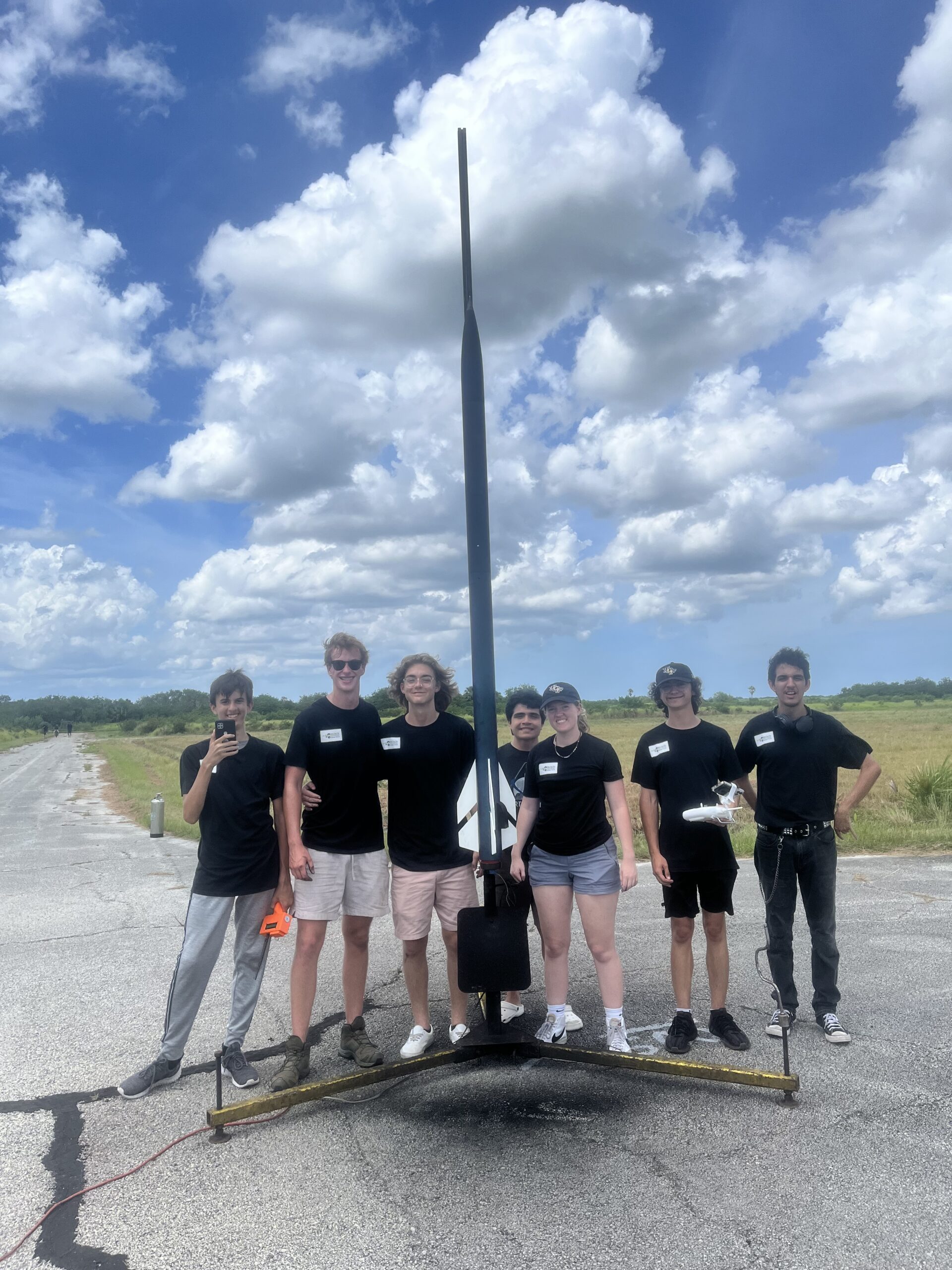 Team True Fire Rocketry Club poses with rocket before launch