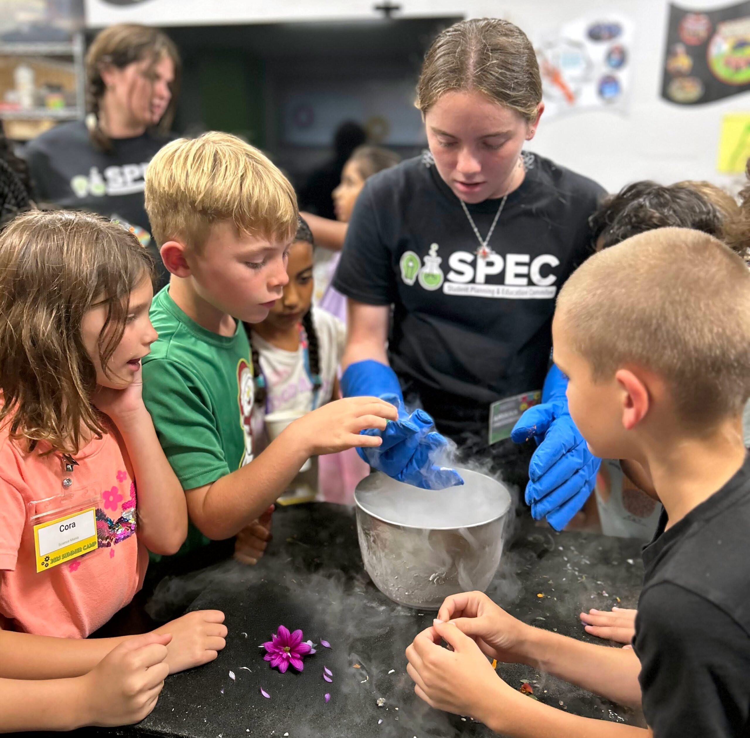 SPEC instructor Ariana demos liquid nitrogen for a group of campers