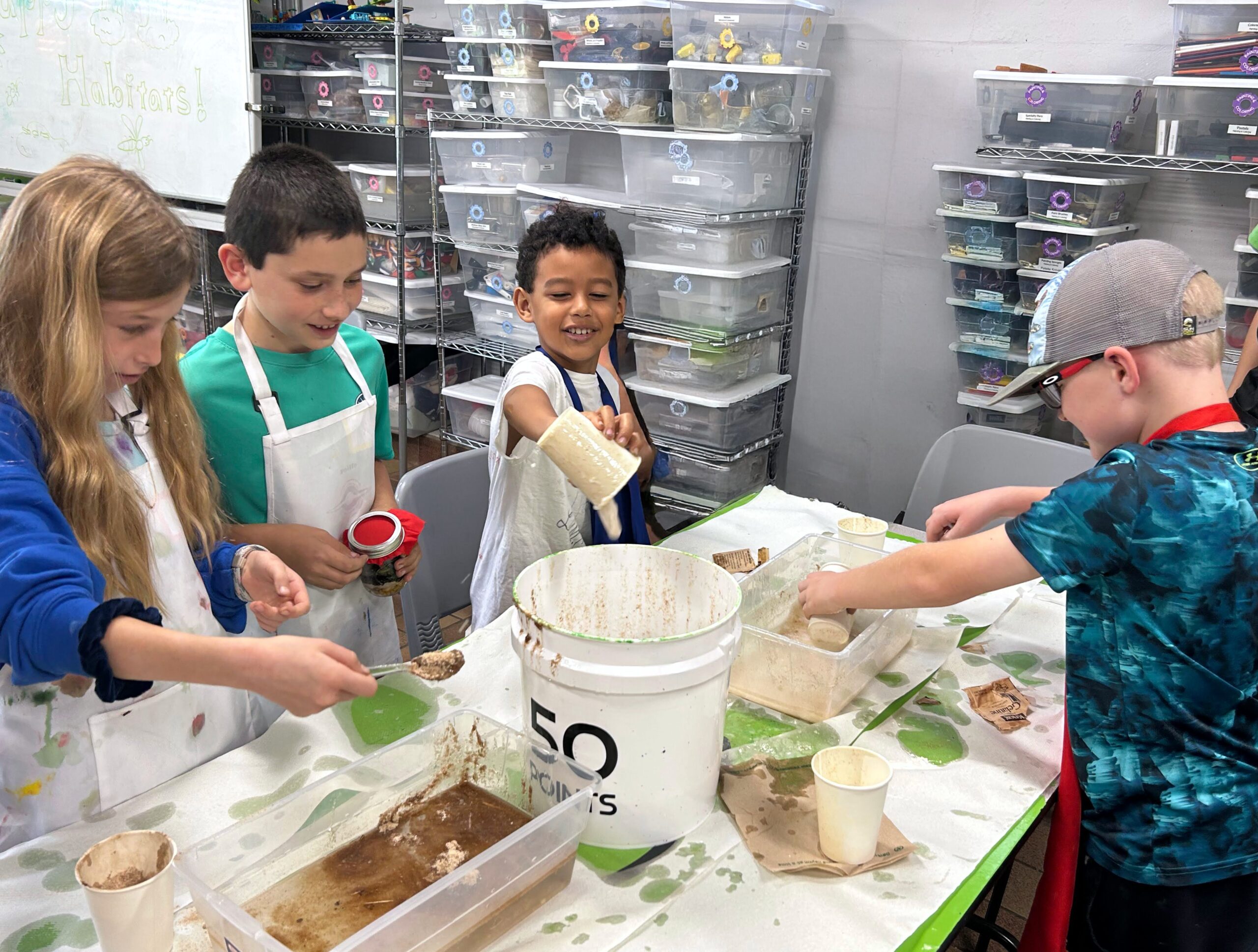 STEAM Saturdays campers simulate an oil spill in Swamp Sleuths class